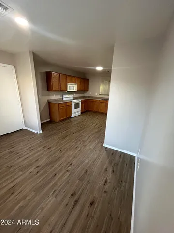 a view of a kitchen with wooden floor