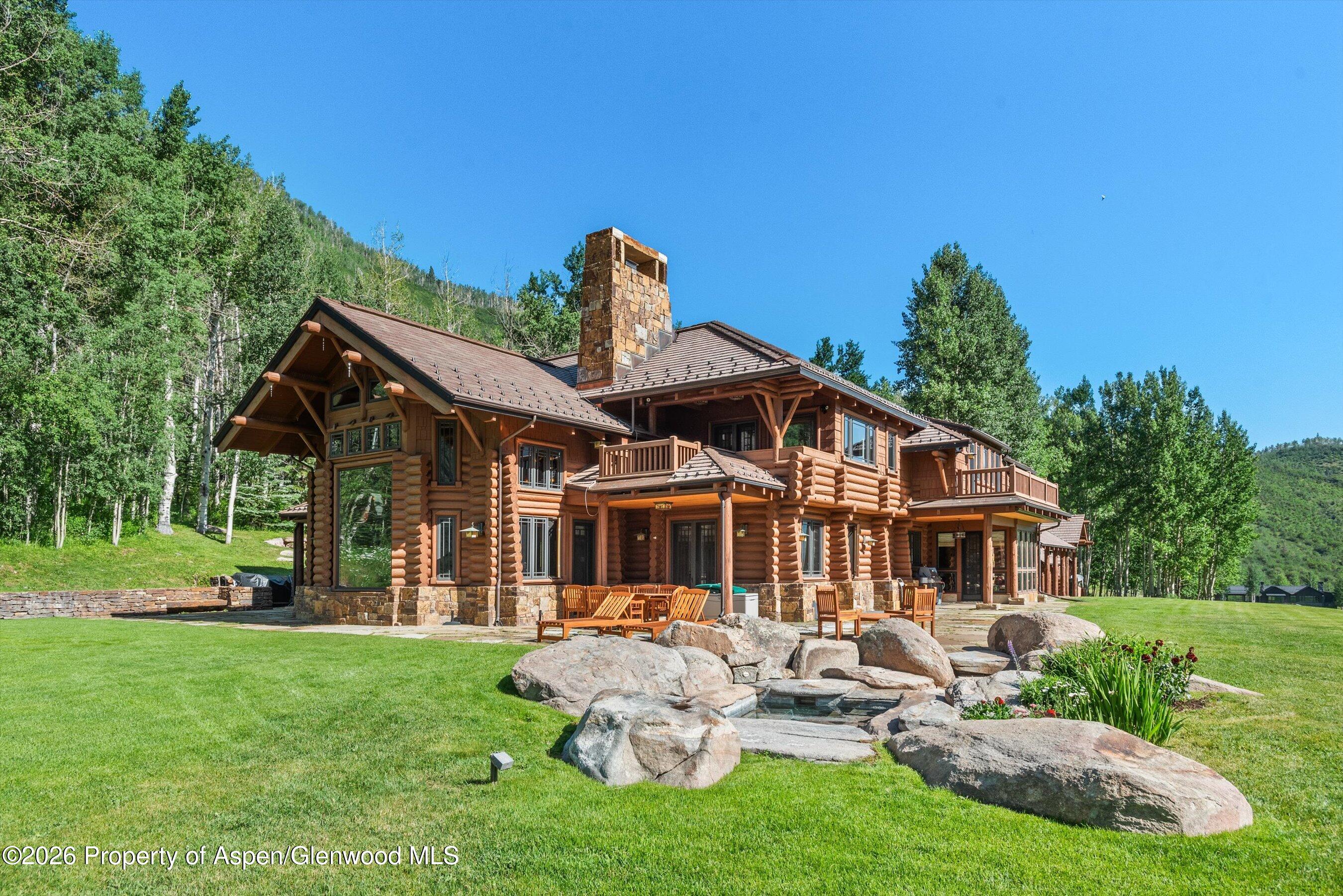 a front view of a house with a yard porch and outdoor seating