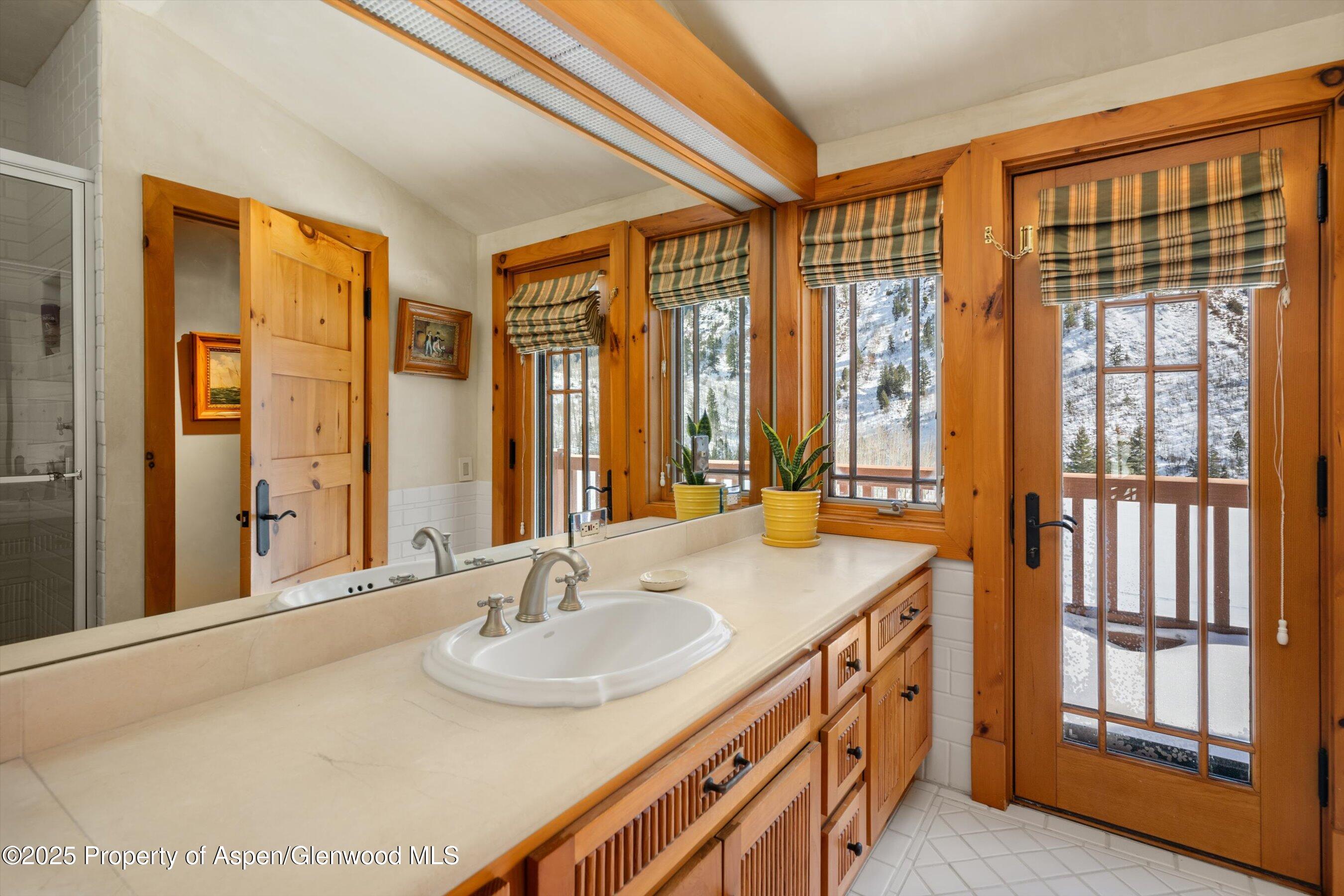 195 North Hayden Road Aspen, CO 81611 - Photo 18 of 39 a bathroom with a sink double vanity and a mirror