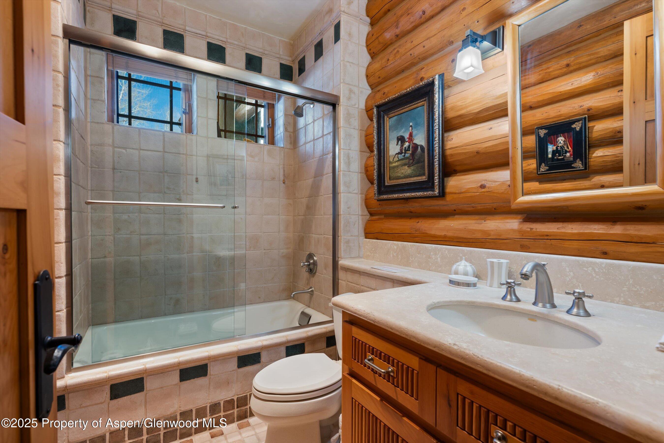 195 North Hayden Road Aspen, CO 81611 - Photo 21 of 39 a bathroom with a granite countertop toilet sink and mirror