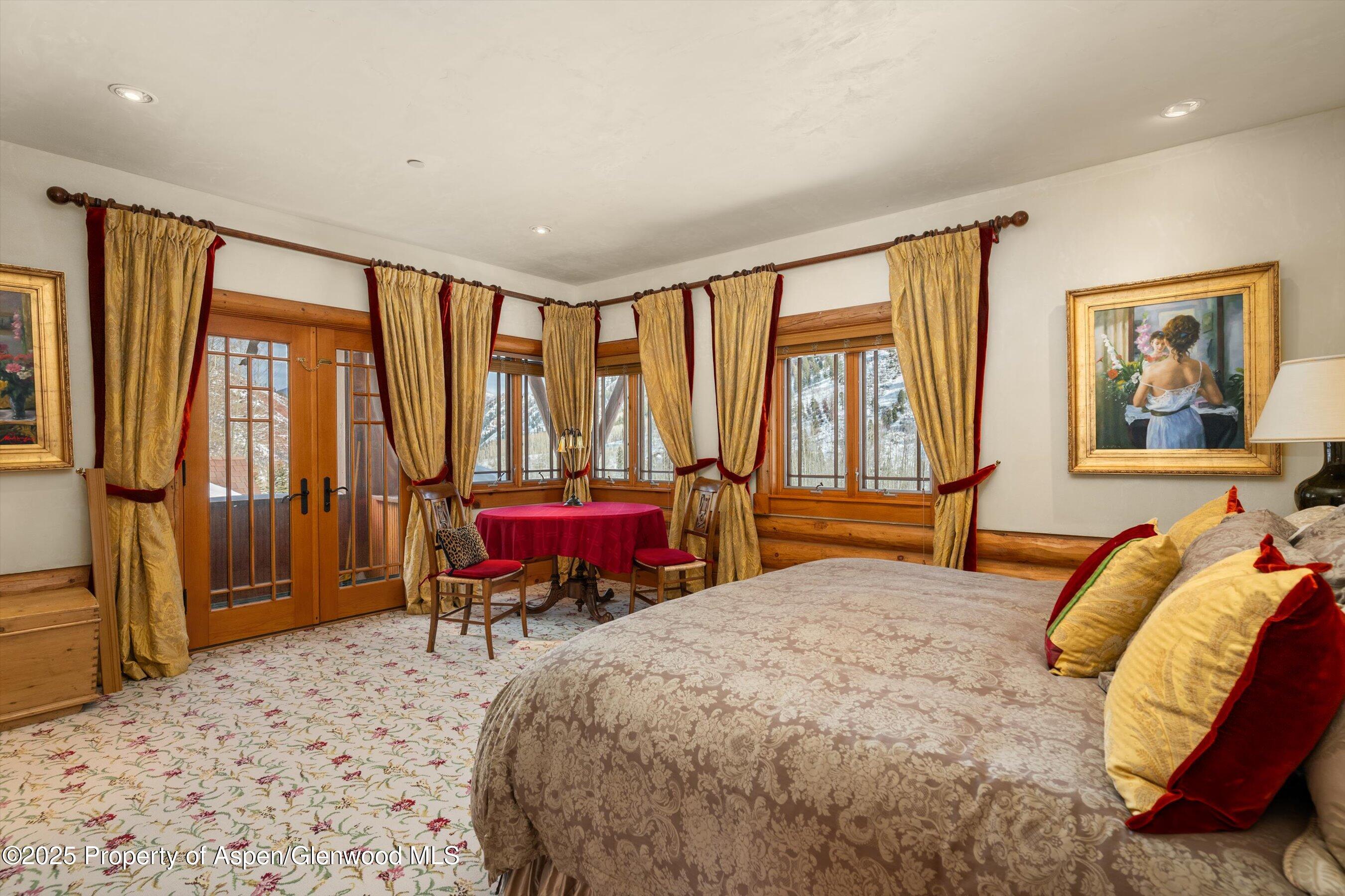195 North Hayden Road Aspen, CO 81611 - Photo 24 of 39 a spacious bedroom with a large bed and a large window