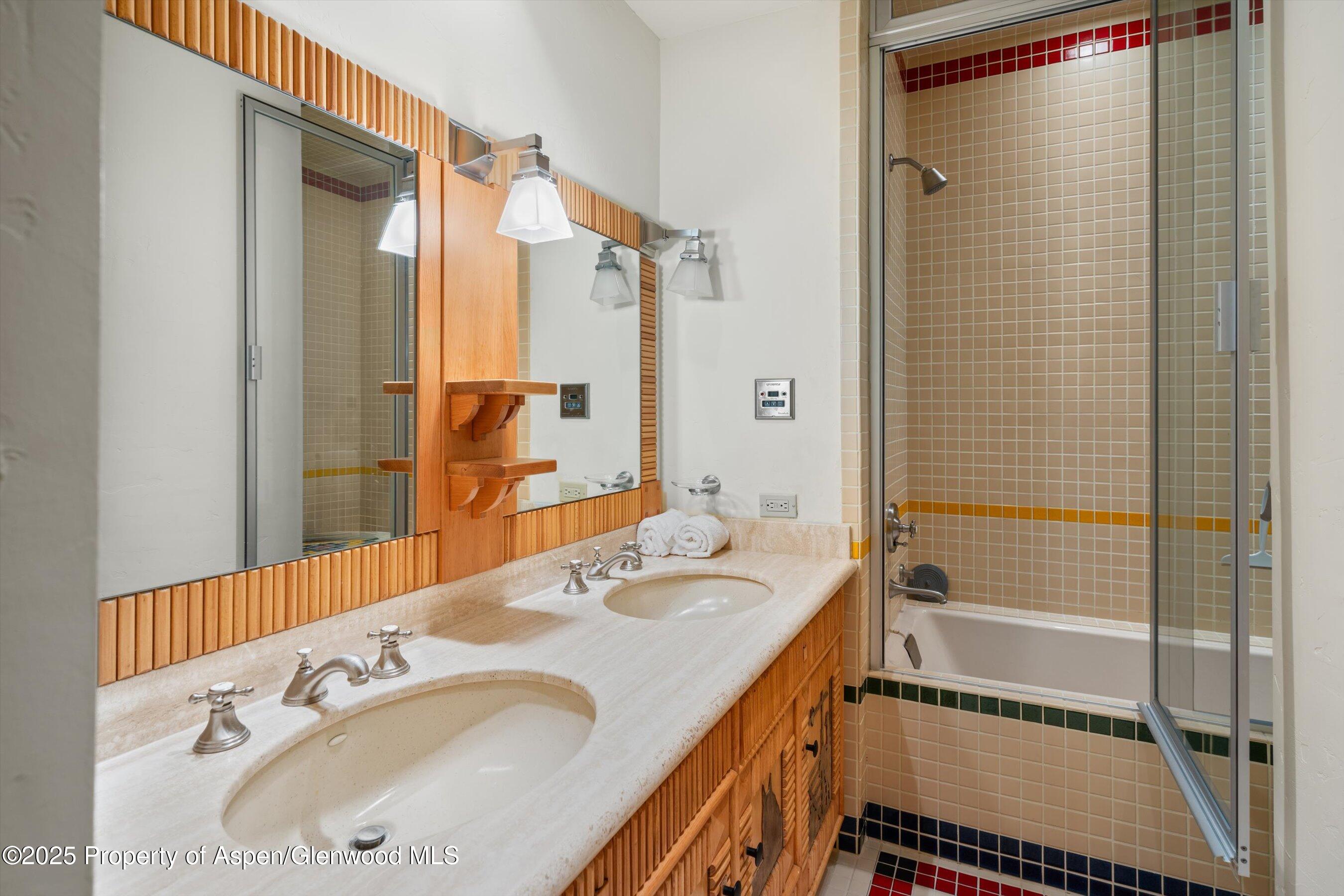 195 North Hayden Road Aspen, CO 81611 - Photo 30 of 39 a bathroom with a sink and a mirror