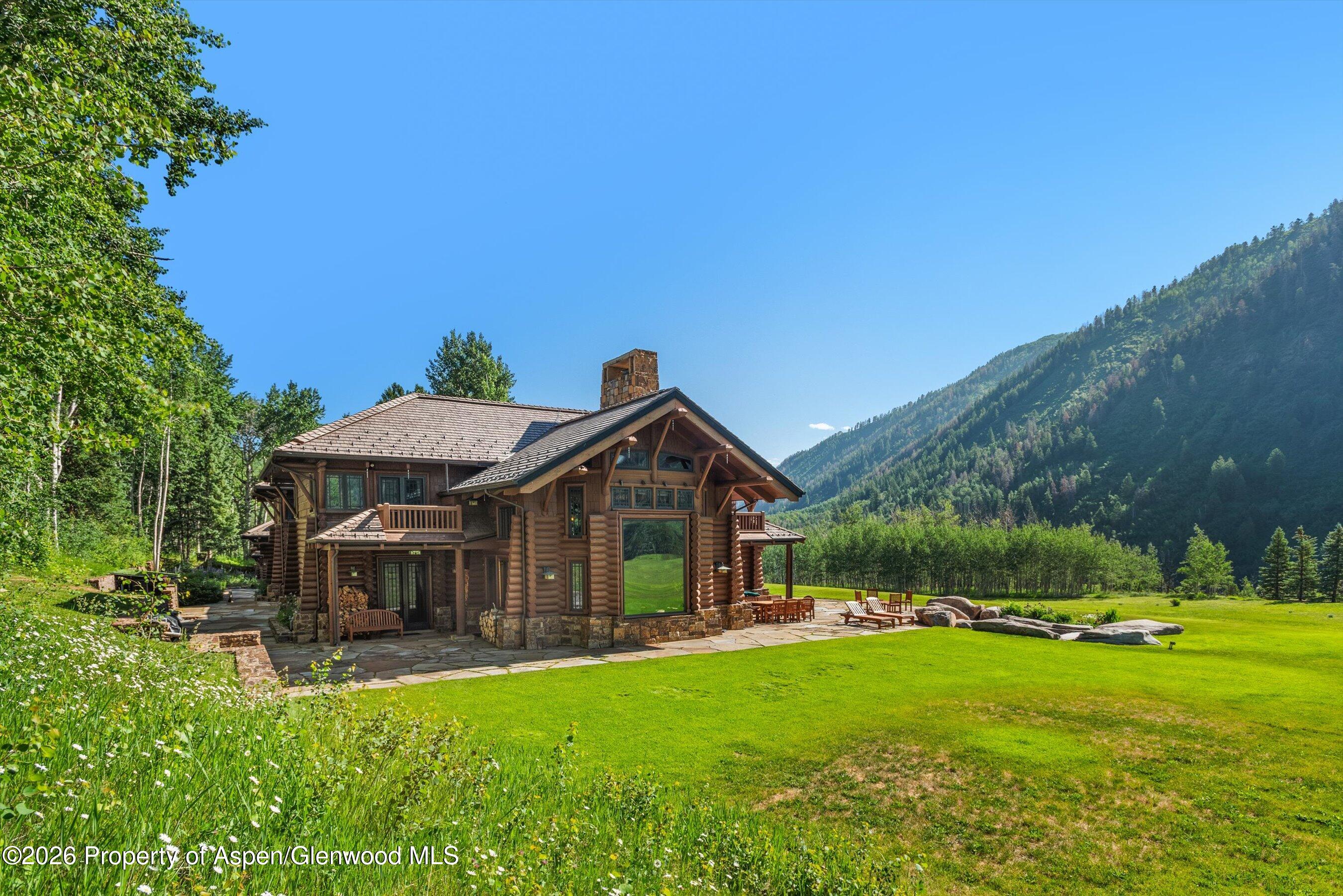 195 North Hayden Road Aspen, CO 81611 - Photo 37 of 39 a front view of a house with a garden