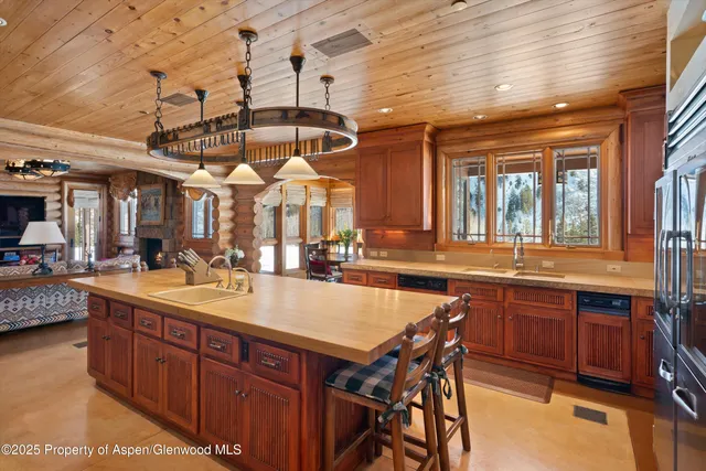 a large kitchen with a table and chairs