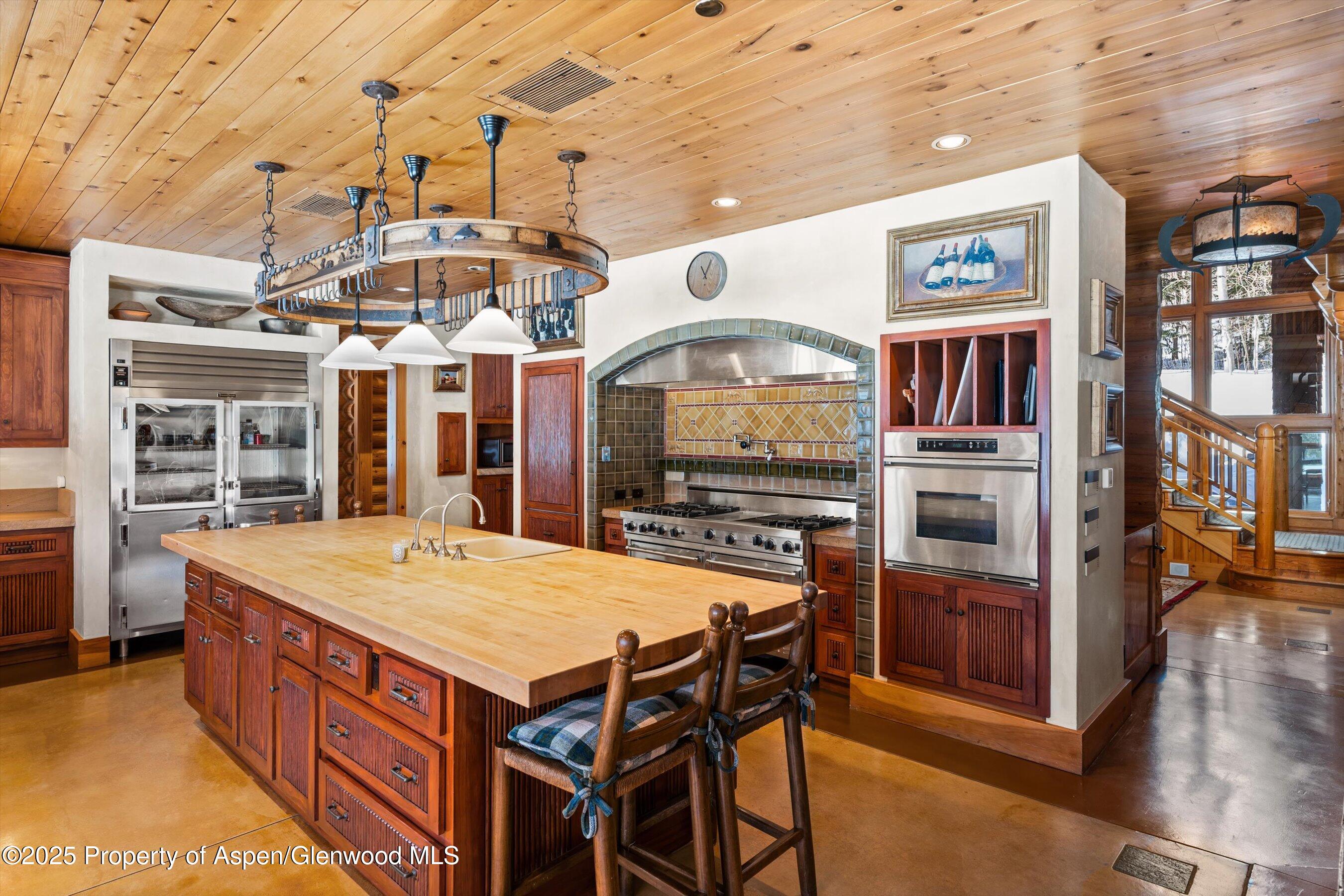 195 North Hayden Road Aspen, CO 81611 - Photo 10 of 39 a large kitchen with a table and chairs