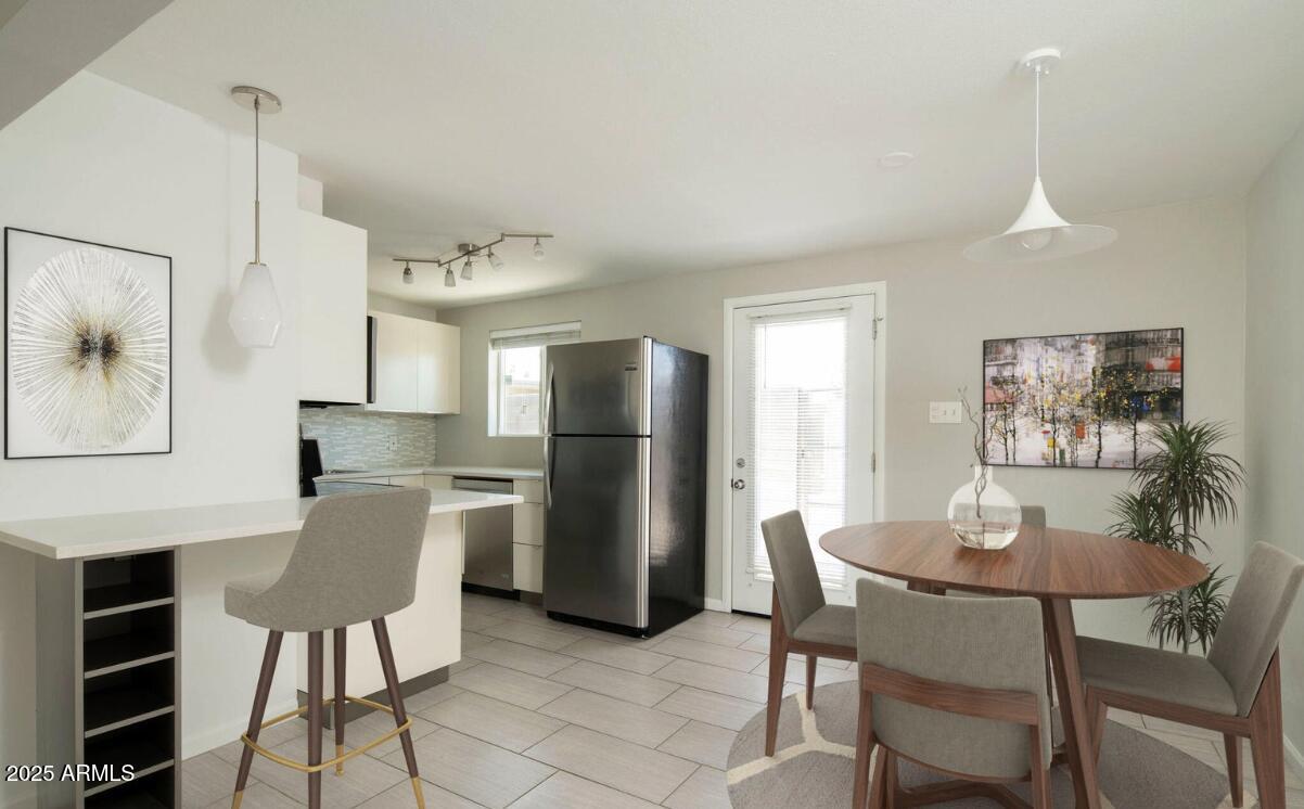 4351 North 36th Place, Unit 3 Phoenix, AZ 85018 - Photo 6 of 11 a view of a dining room with furniture and a chandelier