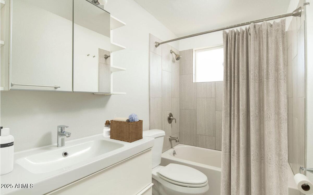 4351 North 36th Place, Unit 3 Phoenix, AZ 85018 - Photo 9 of 11 a bathroom with a sink toilet and shower