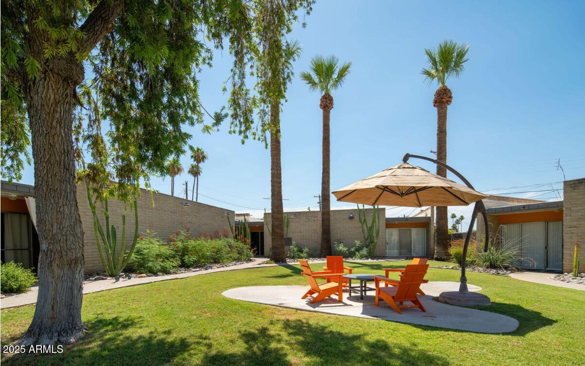 4351 North 36th Place, Unit 3 Phoenix, AZ 85018 - Photo 10 of 11 a view of a patio with a table chairs and a fire pit