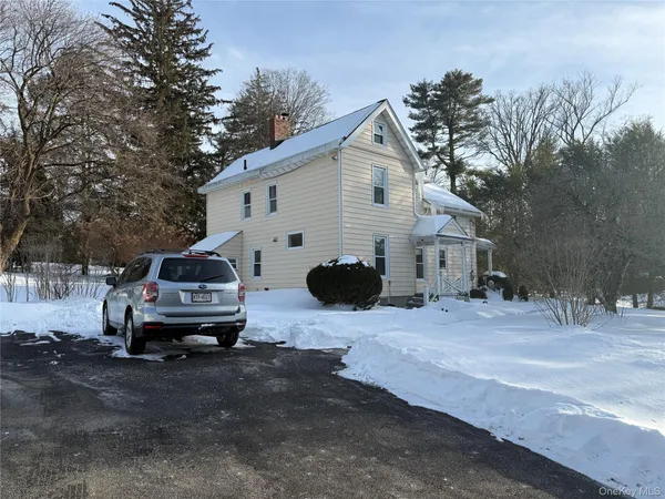 a view of a house with a car parked in front of a house