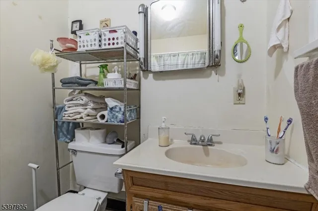 a bathroom with a sink a toilet and a mirror