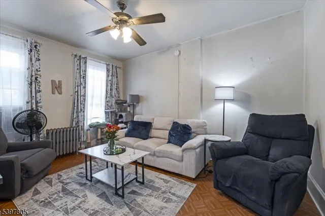 a living room with furniture a lamp and a window