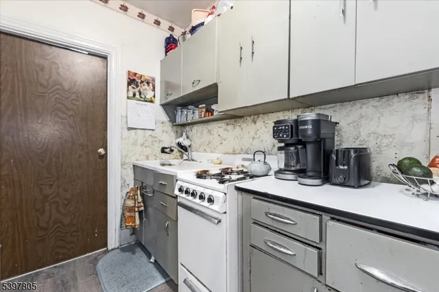 a kitchen with stainless steel appliances granite countertop a sink and cabinets