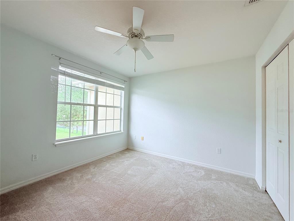 100 Turpial Way, Unit 107 Melbourne, FL 32901 - Photo 11 of 16 an empty room with a window and a fan