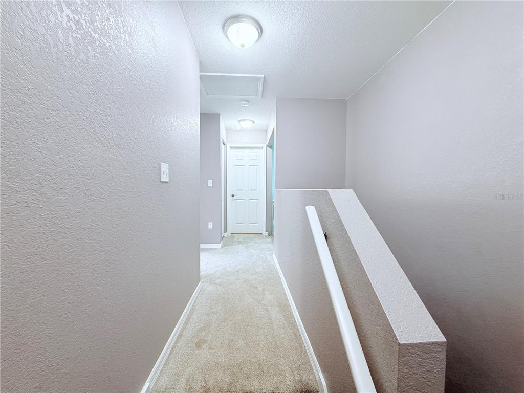 100 Turpial Way, Unit 107 Melbourne, FL 32901 - Photo 12 of 16 a view of hallway with wooden floor
