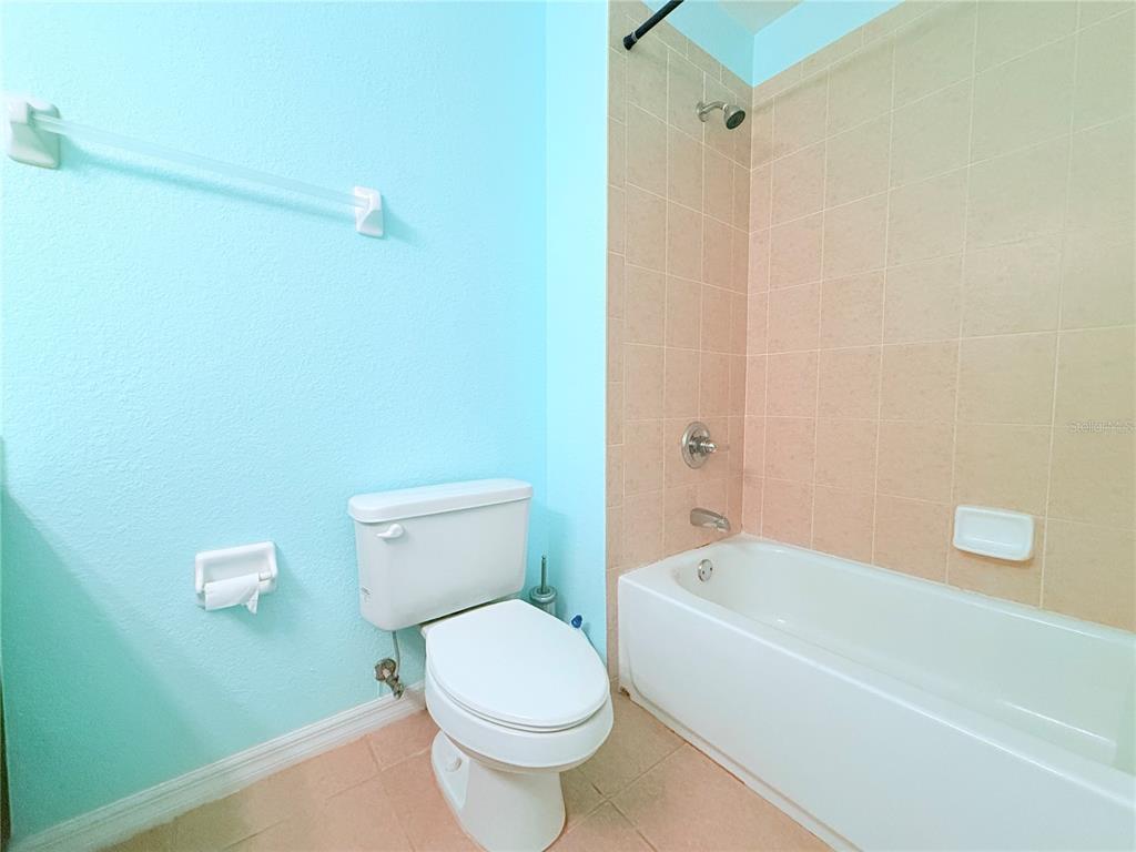 100 Turpial Way, Unit 107 Melbourne, FL 32901 - Photo 15 of 16 a bathroom with a toilet and a bathtub
