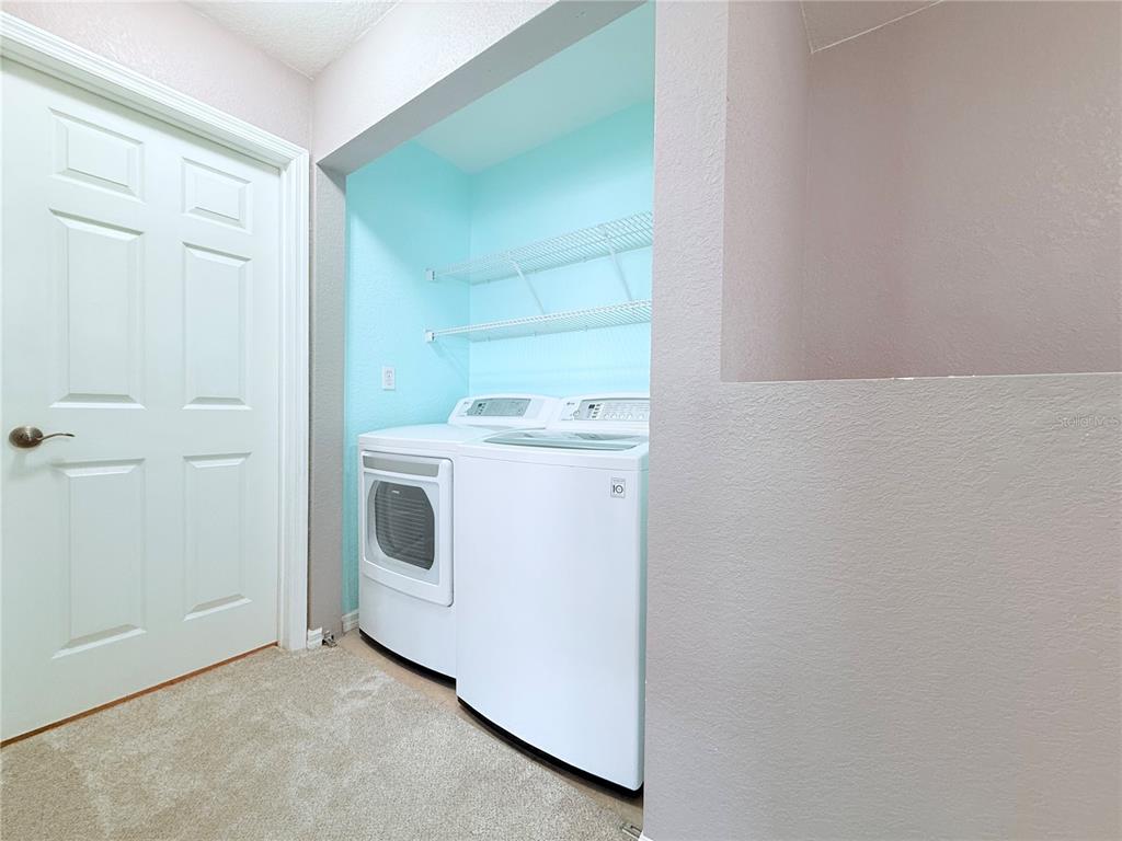 100 Turpial Way, Unit 107 Melbourne, FL 32901 - Photo 16 of 16 a utility room with dryer and washer