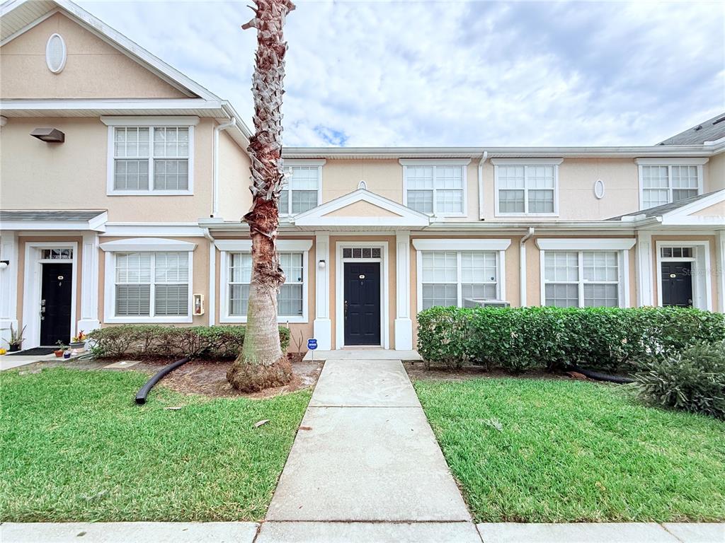 100 Turpial Way, Unit 107 Melbourne, FL 32901 - Photo 2 of 16 a front view of a house with garden