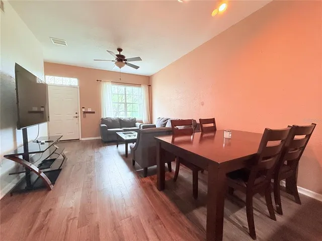 a view of a dining room with furniture window and wooden floor