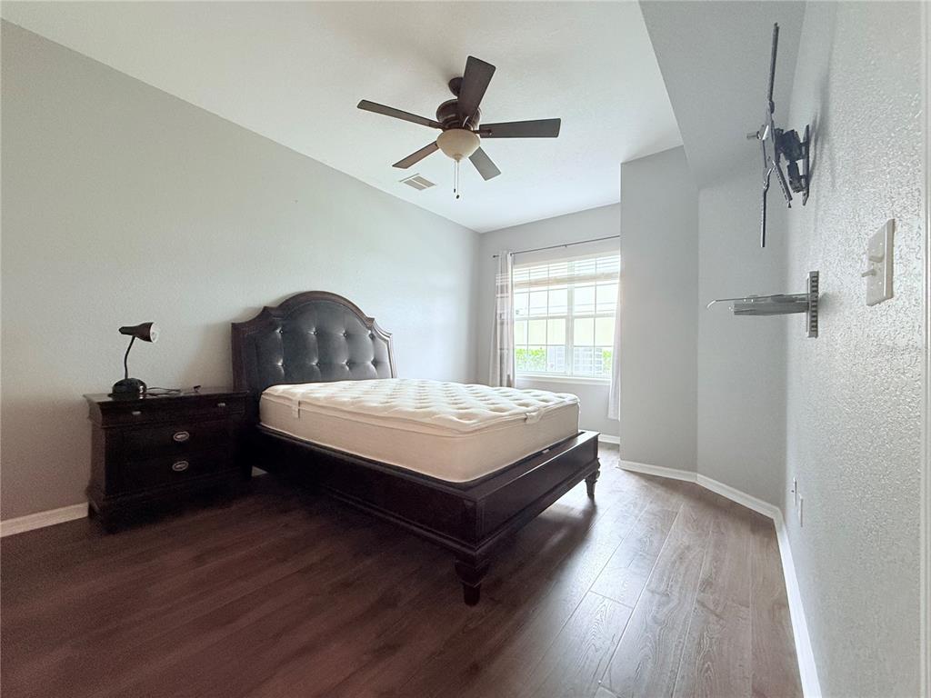100 Turpial Way, Unit 107 Melbourne, FL 32901 - Photo 8 of 16 a bedroom with a bed and window