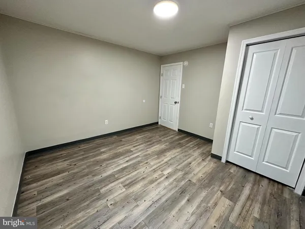 a view of wooden floor and windows in a room