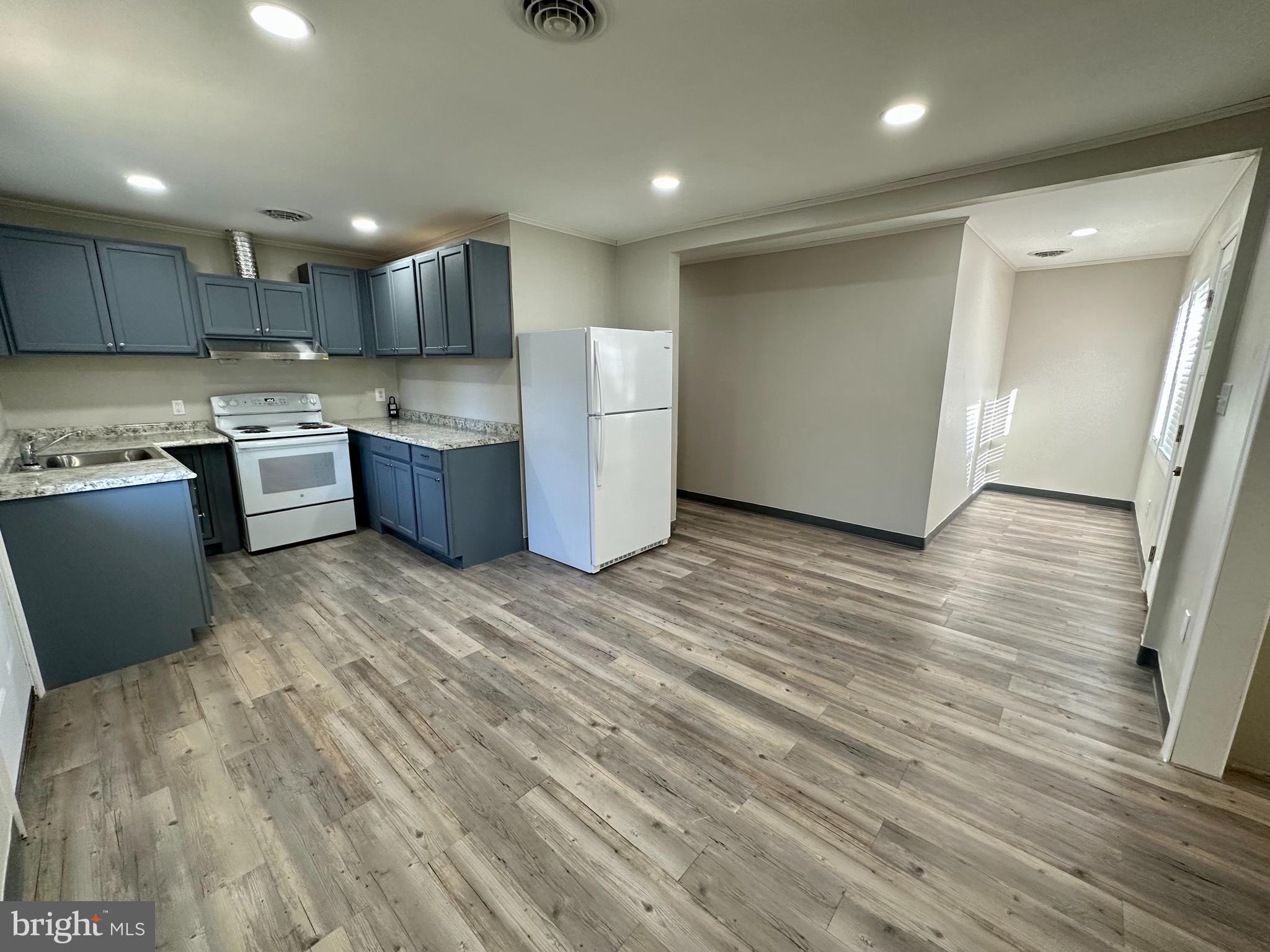 749 River Road Dover, DE 19901 - Photo 8 of 19 a large kitchen with a lot of cabinets and wooden floor