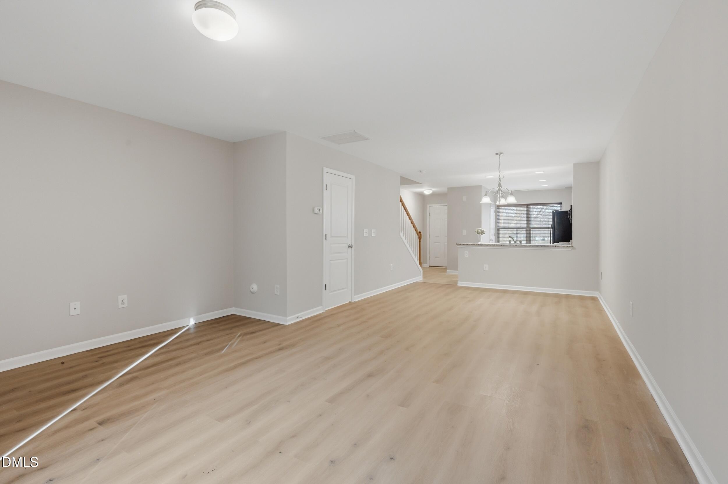 2907 Berkeley Springs Place Raleigh, NC 27616 - Photo 11 of 34 a view of empty room with wooden floor