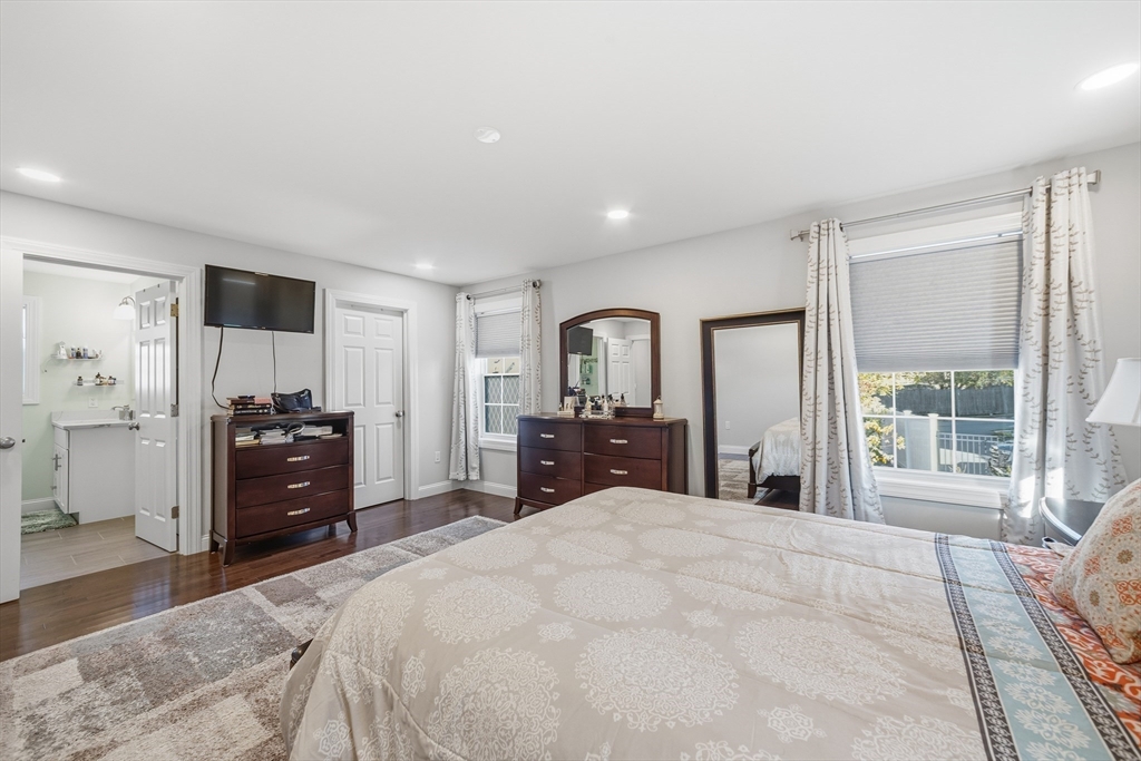 12 Sutton Street Peabody, MA 01960 - Photo 17 of 32 a large bedroom with a bed and a large window