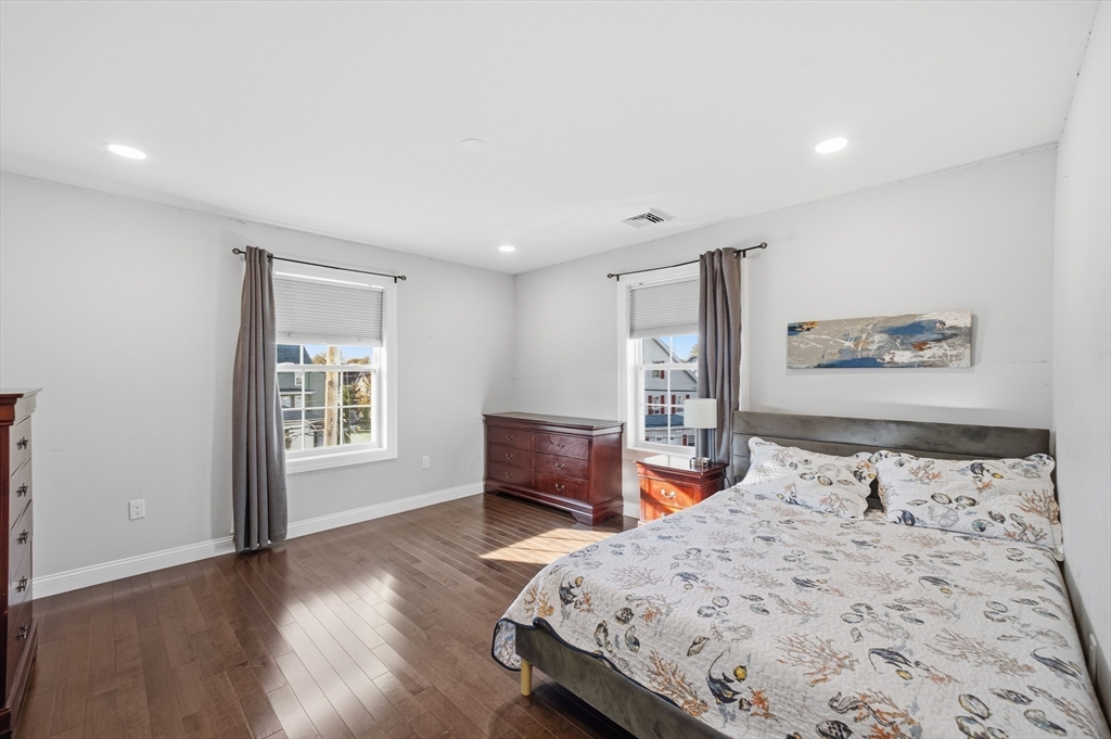 12 Sutton Street Peabody, MA 01960 - Photo 18 of 32 a bedroom with a bed and a dresser with wooden floor