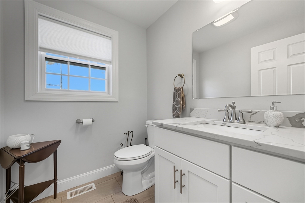 12 Sutton Street Peabody, MA 01960 - Photo 26 of 32 a bathroom with a granite countertop toilet sink and mirror