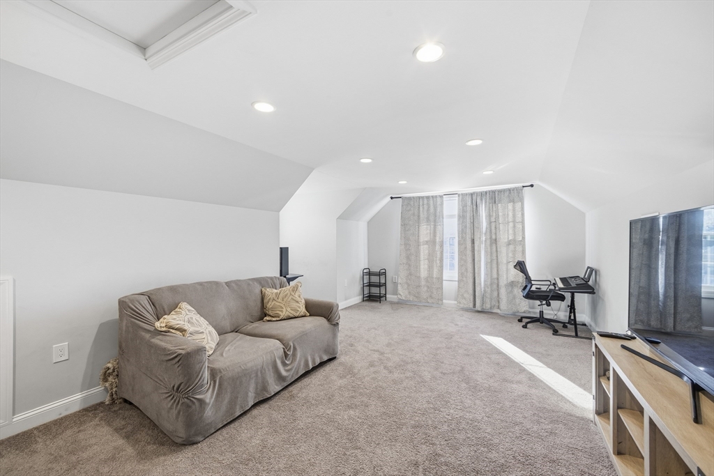 12 Sutton Street Peabody, MA 01960 - Photo 27 of 32 a living room with furniture and a flat screen tv