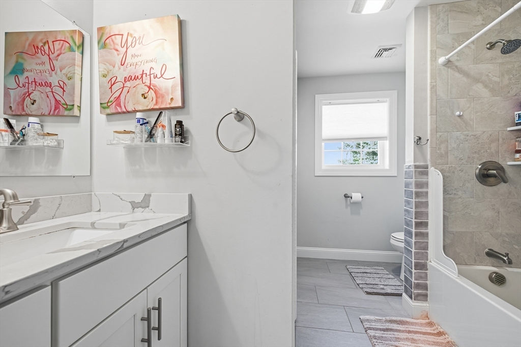 12 Sutton Street Peabody, MA 01960 - Photo 29 of 32 a bathroom with a sink a mirror and a bathtub