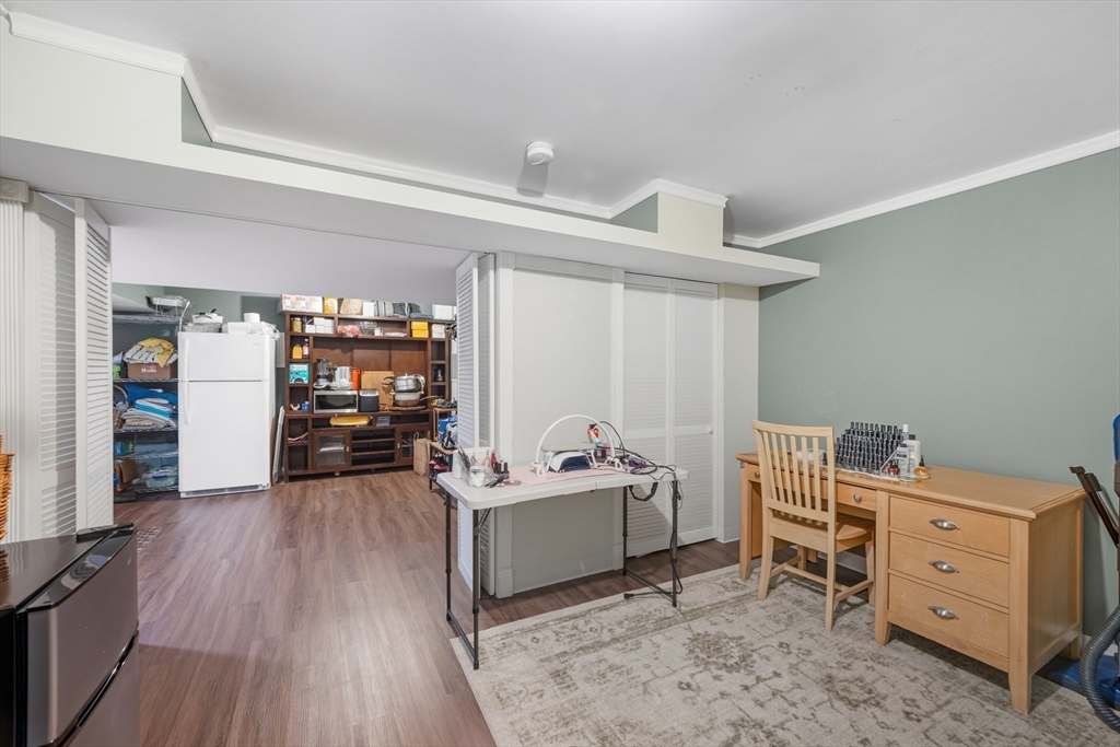 12 Sutton Street Peabody, MA 01960 - Photo 30 of 32 a bedroom with furniture and a wooden floor