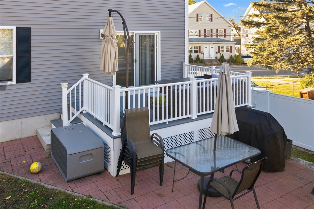 12 Sutton Street Peabody, MA 01960 - Photo 4 of 32 a balcony with table and chairs