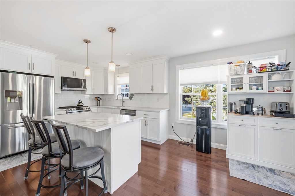 12 Sutton Street Peabody, MA 01960 - Photo 10 of 32 a kitchen with white cabinets and stainless steel appliances