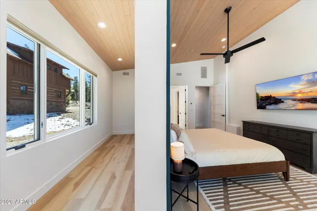 a kitchen with stainless steel appliances kitchen island granite countertop a refrigerator a stove and a sink with wooden floor