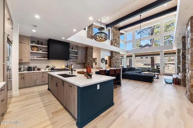 a large white kitchen with a large window