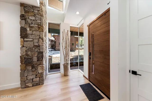 a view of a hallway with wooden floor and entryway