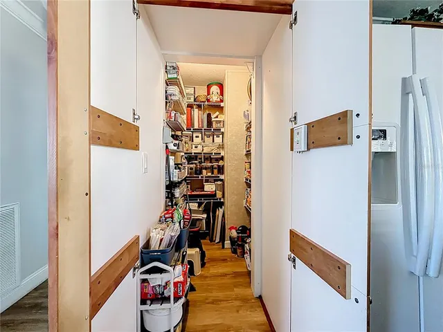 a view of a hallway with wooden shelves