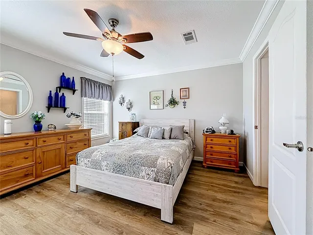 a bedroom with a bed and ceiling fan