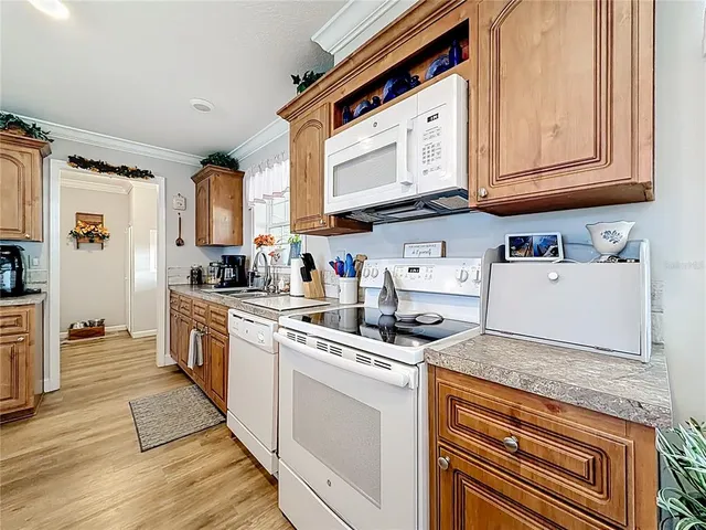 a kitchen with stainless steel appliances granite countertop a stove and a microwave