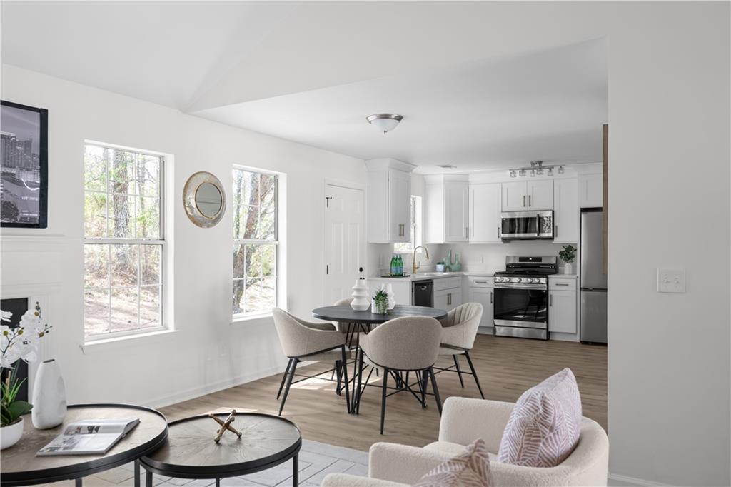2203 Hidden Creek Drive Decatur, GA 30035 - Photo 12 of 24 a kitchen with granite countertop lots of white cabinets a dining table and chairs