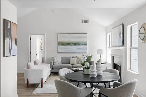 a dining room with furniture and wooden floor