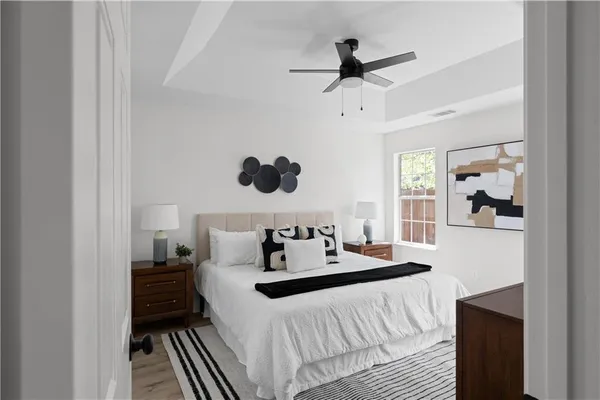 a bedroom with a bed and a large window