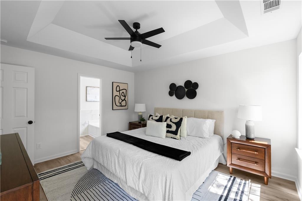2203 Hidden Creek Drive Decatur, GA 30035 - Photo 18 of 24 a bedroom with a large bed and a ceiling fan