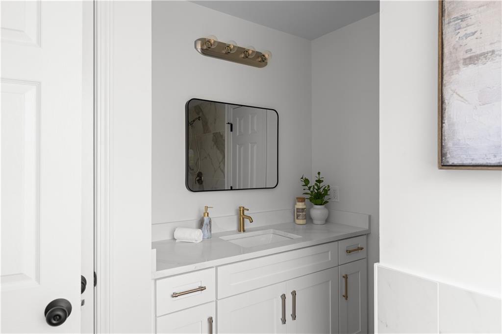 2203 Hidden Creek Drive Decatur, GA 30035 - Photo 19 of 24 a bathroom with a granite countertop sink and a mirror