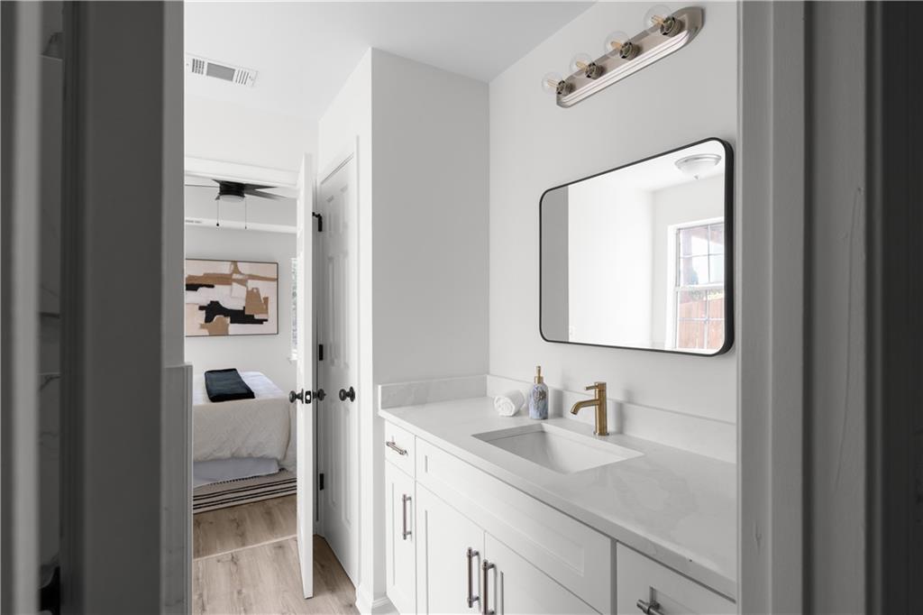 2203 Hidden Creek Drive Decatur, GA 30035 - Photo 22 of 24 a bathroom with a granite countertop sink vanity and mirror