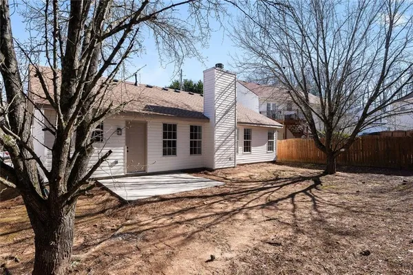 a backyard of a house with large trees