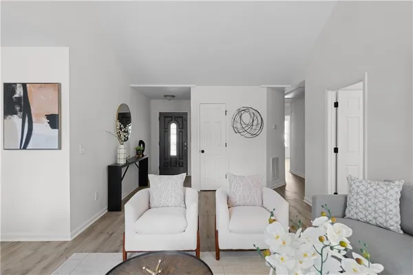a living room with furniture and a clock