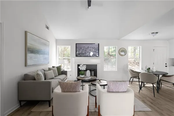 a living room with furniture a fireplace and a table