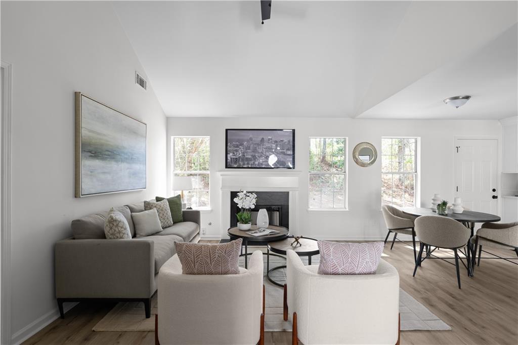 2203 Hidden Creek Drive Decatur, GA 30035 - Photo 5 of 24 a living room with furniture a fireplace and a table